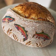 a loaf of bread with fish painted on it