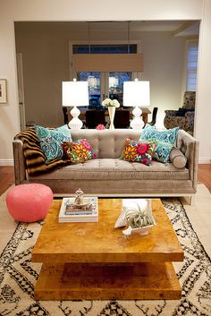 a living room filled with furniture and pillows