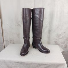 This is a beautiful pair of boots and in such nice conditionFrye knee high equestrian style boots....made in Spain. Matte Taupe leather uppers and shafts with two adjustable straps....brown leather linings and leather soles. You can see from the soles that the boots haven't been worn very much....you can still make out the Frye logo on the bottom. The boots are very clean and ready to go. They are 18 inches tall including a 1 inch heel. The opening at the top is 15 1/2 inches.  Women's size 6 M Classic Brown Knee-high Riding Boots, Classic Brown Knee-high Boots For Riding, Brown Wide Calf Knee-high Boots For Riding, Riding Knee-high Boots With Leather Sole, Leather Knee-high Riding Boots, Leather Knee-high Boots For Riding, Leather Knee-high Riding Boots, Fitted, Fitted Leather Knee-high Riding Boots, Western Style Leather Knee-high Boots For Formal Occasions