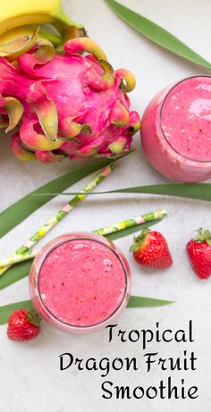 tropical dragon fruit smoothie with strawberries and bananas on the side next to it