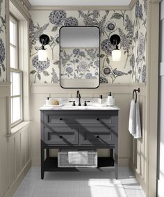 a bathroom with two sinks and a large mirror above the sink, in front of a wallpapered background