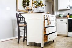 a kitchen with an old fashioned stove in the center and two chairs on the other side