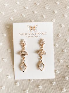 two pairs of earrings on top of a card