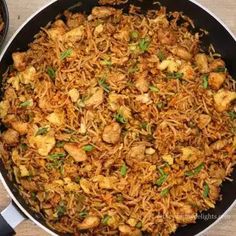 chicken and rice in a skillet on a wooden table