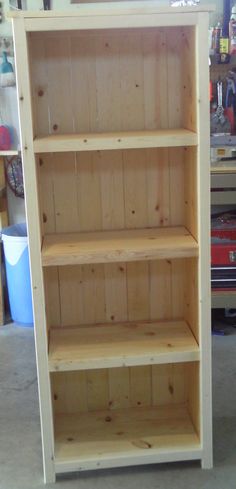 a wooden bookcase sitting in a garage