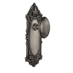 an antique style door handle with a decorative design on the front and back of it