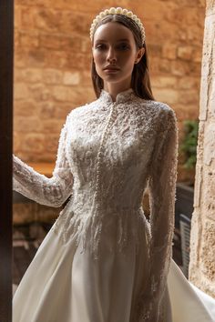 a woman wearing a white dress and a tiara