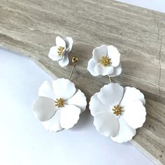 New~ Anthropologie Captiva Floral Front White Flower Jacket Earrings Blooming Flower Blossoms Steal The Show With This Front/Back Jacket Style Earring. Offering A Fresh Floral Look From Both Sides, This Pair Of Earrings Can Also Be Split And Worn As Just Small Flower Studs Or Add The Back Jacket To Another Pair Of Stud Earrings You Already Own.Two Pairs In One! Approx. 2-3/4l", 1-5/8"W Overall. Sm. Flower: 1"L, 1"W. Lg. Flower: 1-5/8"L, 1-5/8"W. Painted White Metal; Gold Plated Center. Nwot. Ant Chic White Flower-shaped Earrings, Chic White Flower Earrings For Wedding, Spring Party White Flower Earrings, Chic White Flower Wedding Earrings, Chic White Flower Earrings For Spring, Trendy White Wedding Earrings, Chic White Flower Earrings Gift, Chic White Flower Earrings For Gift, Chic White Flower Earrings As A Gift