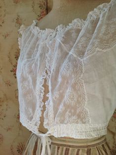 "breath taking fresh antique camisole, wedding top. sleeveless lace summer top in excellent condition. bust 92 cm 36\" waist 66 cm 26\" length 38 cm 15\" the shoulders have ruffled lace and made on them you can see see little roses made of soft silk ribbons" White Lace Trim Bodice For Wedding, White Lace Trim Wedding Bodice, Delicate Lace Trim Camisole Top, Underbust Lace Bodice With Lace Trim, Delicate Lace Tops For Daywear, White Wedding Corset With Delicate Lace, White Delicate Lace Wedding Corset, Delicate Fitted Lace Camisole, Fitted Delicate Lace Camisole