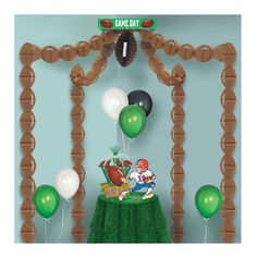 a balloon arch with balloons and footballs on it