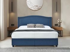 a bed with blue upholstered headboard and foot board in a bedroom setting