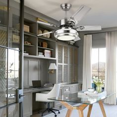 a glass desk in the middle of a room with shelves on either side and a chair at the end