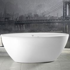 a large white bath tub sitting on top of a tiled floor next to a wall