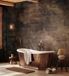 an old fashioned bathtub in a rustic bathroom with dark walls and wood flooring