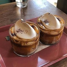 two desserts are sitting on a red tray