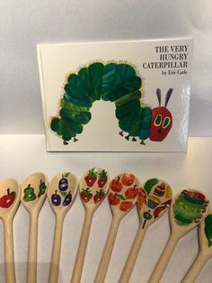 the very hungry caterpillar wooden spoons are lined up