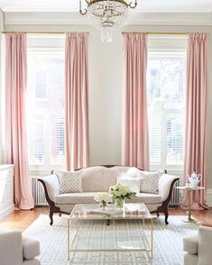 a living room filled with furniture and a chandelier