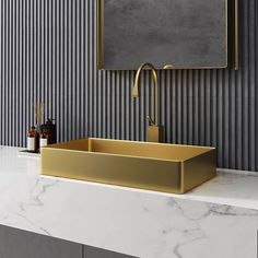 a bathroom sink with a gold faucet and marble counter top in front of a striped wall