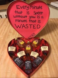 a heart shaped box filled with miniature bottles and an inscription on the inside saying every minute that is spent without you is a minute that is wasted