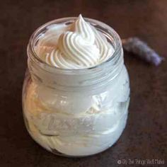 a jar filled with whipped cream sitting on top of a table