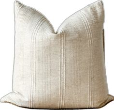 a cream colored pillow with pleated stripes on the front and back, sitting on a white background