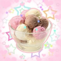 three scoops of ice cream in a glass bowl on a pink and white background