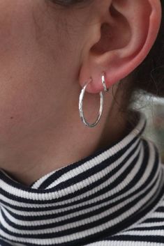 Absolute classics, the medium 2.5cm hammered hoop earrings. Made from substantial 2mm recycled silver wire they are hammered to perfection to catch the light. With a comfortable rounded end behind the earlobe. They are fitted with posts and butterflies to make them easy to wear.  They measure approx 2.5cm across and look fab with my little hammered huggies in the same style. My whole range works beautifully together for the dream stack.  Packaged in beautiful reusable and recycled packaging ready to give. Handmade Hoop Earrings, Sweet Earrings, Hammered Hoop Earrings, Tiny Star, Recycled Silver, Hammered Silver, Sterling Silver Hoops, Same Style, Recycled Sterling Silver