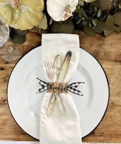 a place setting with silverware and napkins