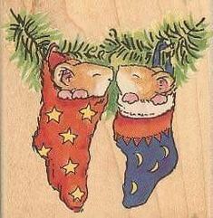 an image of two mice in stockings on christmas eves day with pine tree branches