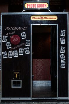 an automated photo booth is decorated with stickers on the door and windows, as well as photos