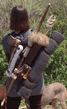 a woman in a medieval outfit with two dogs on the side and another dog walking behind her