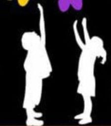 the silhouettes of two children are playing with butterfly shaped kites on a black background