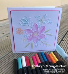 a card with crayons and markers next to it