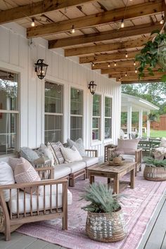 a porch with couches, tables and potted plants on the rugs outside