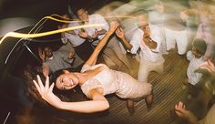 a group of people dancing on a wooden floor