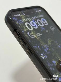 an open cell phone with flowers on the screen and numbers printed on its back side