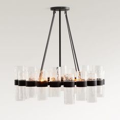 a chandelier with many glasses hanging from it's center rod and lights on each end