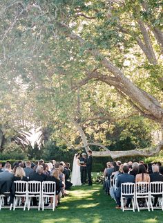 an outdoor wedding ceremony in the grass