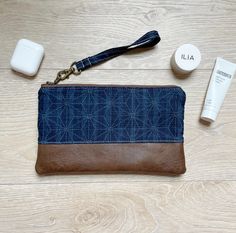 "Navy blue geometric wristlet with faux leather. This small purse is perfect to carry all your essentials for a night out or shopping with the girls. It is also great to add to your diaper bag, tote bag or beach bag to contain your money and cards. It is so versatile and is made with quality materials to last. This makes a great teacher gift, bridesmaid gifts, birthday gift or just great for yourself! Dimensions: 9\" W and 6\" tall. Features: antique brass zipper and swivel clasp zipper closure Faux Leather Wristlet, Summer Clutch, Diaper Bag Tote, Geometric Fabric, Great Teacher Gifts, Gray Fabric, Gifts Birthday, Leather Wristlet, Small Purse