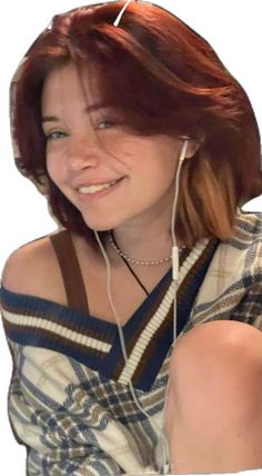 a woman with headphones is smiling and posing for the camera while she has her hair pulled back