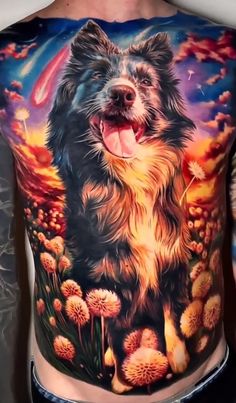 a man with a dog tattoo on his stomach and chest is standing in front of flowers