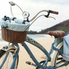 a blue bicycle parked on top of a sandy beach