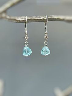 Handmade Sky blue quartz gold dangly earrings for women.   Sparkling sky blue quartz drops in a unique facetted cut are paired with sparkling pave set crystals are wrapped in your choice of Sterling Silver , rose gold or 14k gold fill  and hang from matching leverbacks (pictured) or French Hook Ear Wires. Lovely lightweight earrings.  These would make a wonderful gift for a wife or girlfriend with a November birthday.  Sky Blue Topaz Quartz Gemstones are dainty approx 8 x 8mm or 3/8" wide  Over Faceted Blue Topaz Drop Earrings, Blue Topaz Faceted Dangle Earrings, Faceted Blue Topaz Dangle Earrings, Aquamarine Gemstone Dangle Jewelry, Blue Topaz Briolette Gemstone Earrings, Blue Dangle Birthstone Earrings, Blue Birthstone Dangle Earrings, Aquamarine Gemstone Drop Earrings, Aquamarine Dangle Earrings With Ear Wire