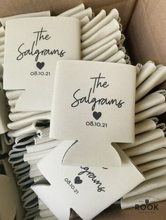 wedding favors in a box with the names of their guests and date printed on them