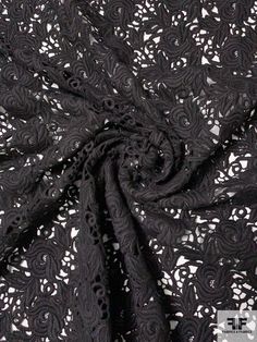 black lace fabric with white flowers on it