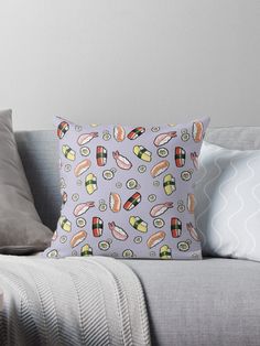 a pillow with sushi on it sitting on a couch