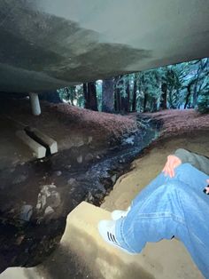 a person sitting on some steps in the woods