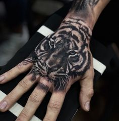 a hand with a tiger tattoo on it