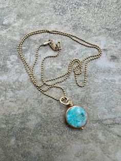 A gorgeous ocean blue Turquoise coin encased in 24k gold electroplate, wrapped in 14k gold filled wire... Sitting simply on an 18" 14k gold filled, 1mm ball chain and closes with a 14k gold filled lobster clasp. Blue Hammered Jewelry As Gift, Blue Hammered Jewelry As A Gift, Blue Hammered Jewelry For Gift, Round Blue Turquoise Necklace For Healing, Gold Turquoise Necklace With Round Beads As A Gift, Handmade Gold Turquoise Necklace With Round Beads, Blue Turquoise Necklace For Healing, Handmade Dainty Gold Turquoise Necklace, Yellow Gold Turquoise Necklace With Round Beads As Gift