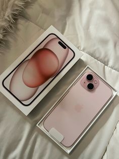 an apple iphone 11 pro in its box on a bed with white furnishing